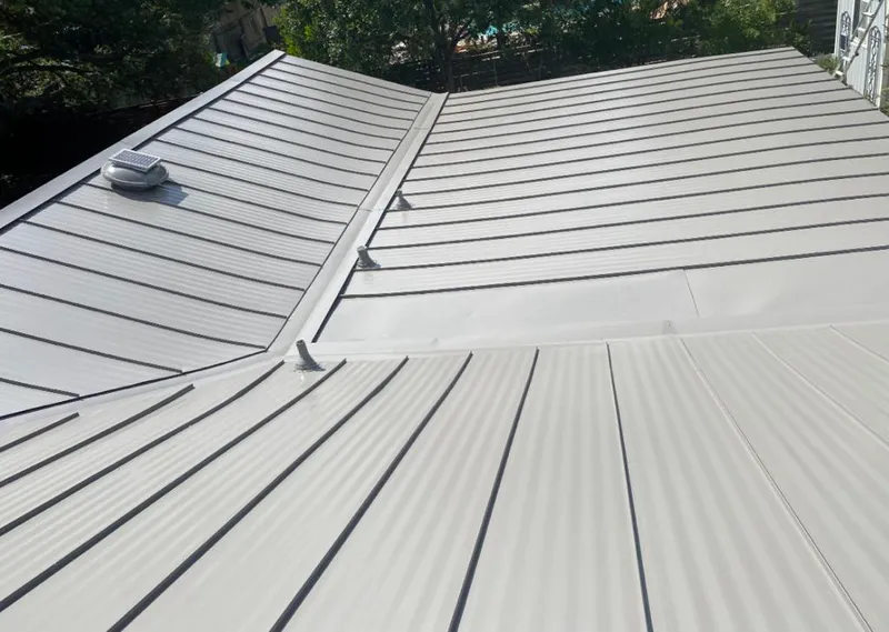 Solar attic fan installed on a metal roof for Roof Ventilation in Beekman